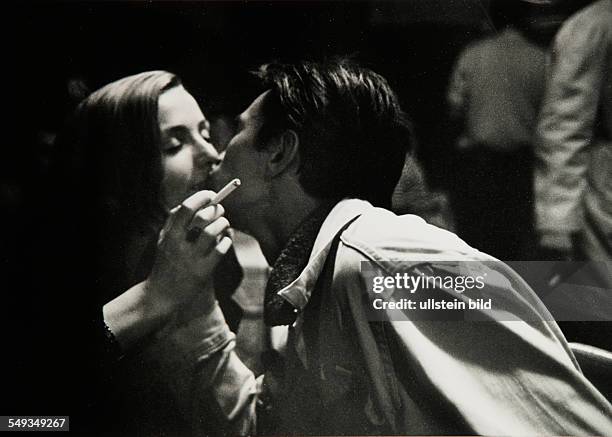 Lovers kissing in a Berlin pub