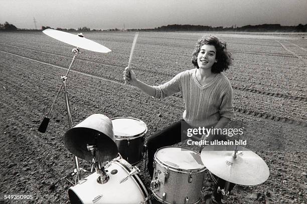 Drummer Nicolle Meyer, woman drummer playing drums on a field.