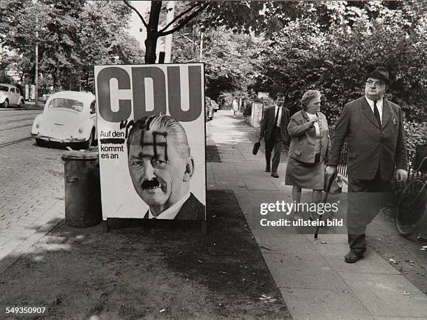 Germany, Hamburg, election campaign of Kurt Georg Kiesinger for the CDU party, poster with his portait with swastika smeared on it.