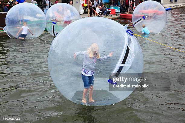 Kieler Woche 2011, sailing event, summer fair, childrens festival, children playing in large balloon on the water surface