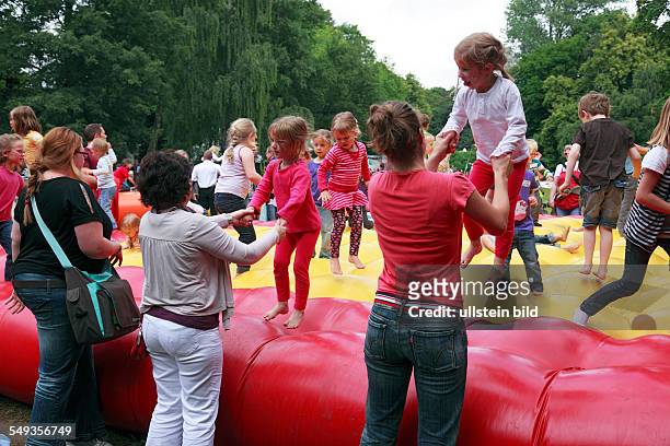 Summer fair in Kiel Duesternbrook, childrens festival on the Krusenkoppel, adventure playground, children jumping on a moon bounce