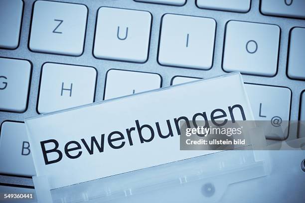 Eine Mappe für Akten im Hängeregister vor einer Computertastatur zum Thema: Bewerbungen