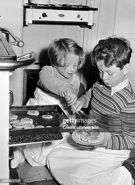 Germny, siblings baking biscuits in the fifties