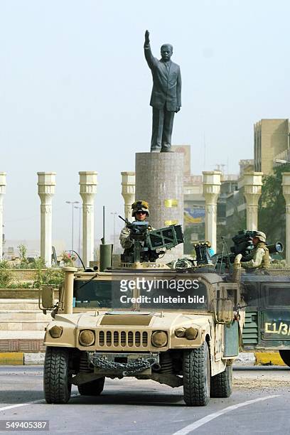 Iraq, Baghdad: US American troops move into the center of Baghdad to the Al-Ferdous square . A statue in the background