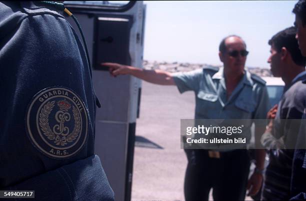 Spain, Tarifa: Immigrants are arrested after their arrival by the Guardia Civil. They will be brought to the foreign police. Logo of the Guardia Civil
