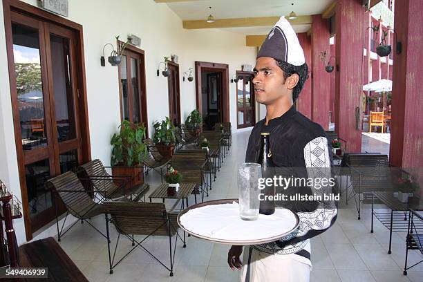 Sri Lanka, Kandy: Pupil of the Don Bosco center for vocational training for former street kids or children of poor families. A waiter with a cap