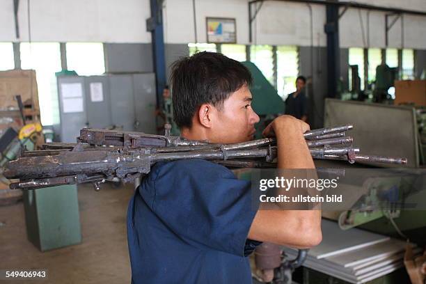 Cambodia. Phnon Penh: the technical department of the Don Bosco school works machine guns to chairs, benches, tables after the demobilization