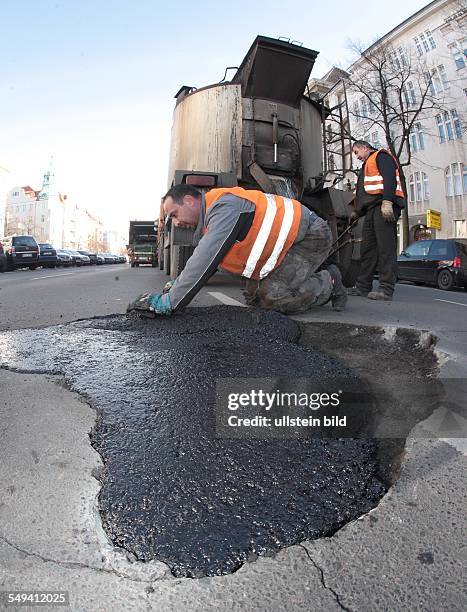 Berlin - Reparation of road holes after the freeze-up period, street "Kaiserdamm"