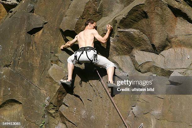 Germany, Hattingen: Climbing garden of the "Deutschen Alpenverein DAV Isenberg". A climber at the rock face