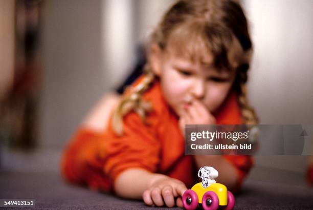 Germany: A child playing with Snoopy.