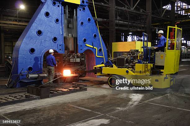 Germany, Bochum: Forging of the 5 tons hammer of the wheel tyre and wheelset manufacturer Bochumer Verein Verkehrstechnik. Workers at forging