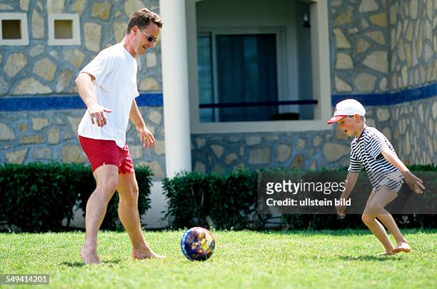 Turkey, Side: Robinson Club.- Pamfilya Hotel; father and son playing soccer.