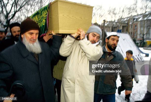 Germany, Duisburg-Bruckhausen, 1997: Turks in Germany.- Death prayer for a Turk at a playground, Heinrichsplatz; transport to the car.