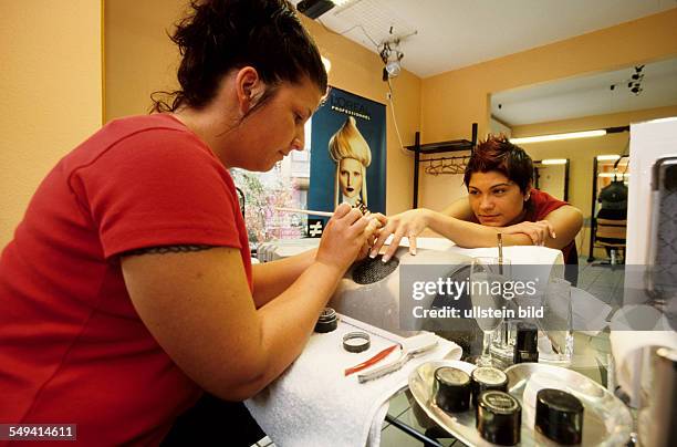 Germany, Waltrop, 06.2002: Turkish Nights in the Ruhr Area.- Guelcan sitting in the shop to get polished her fingernails.