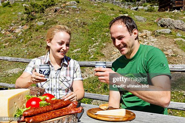 South Tyrol: Brotzeit : young couple having a snack on the alp