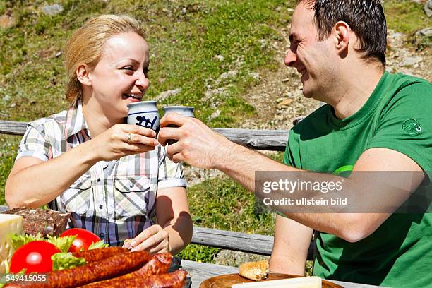 South Tyrol: Brotzeit : young couple having a snack on the alp