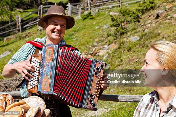 South Tyrol: Brotzeit : young couple having a snack on the alp