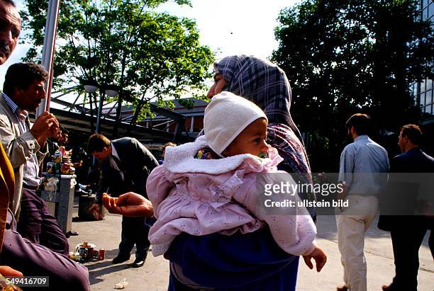 Germany, Dortmund: Poverty in Germany.- A beggar with her child.