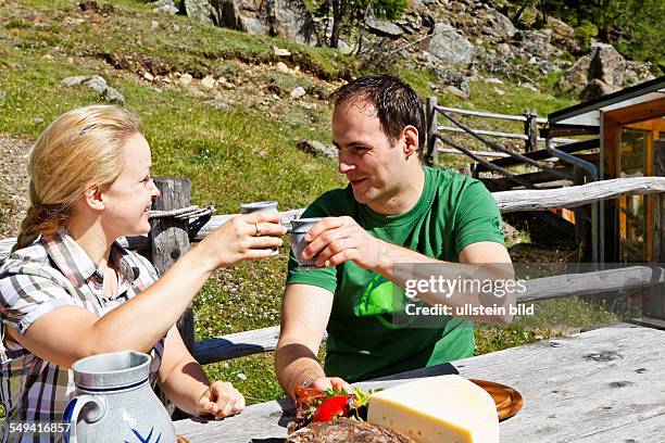 South Tyrol: Brotzeit : young couple having a snack on the alp