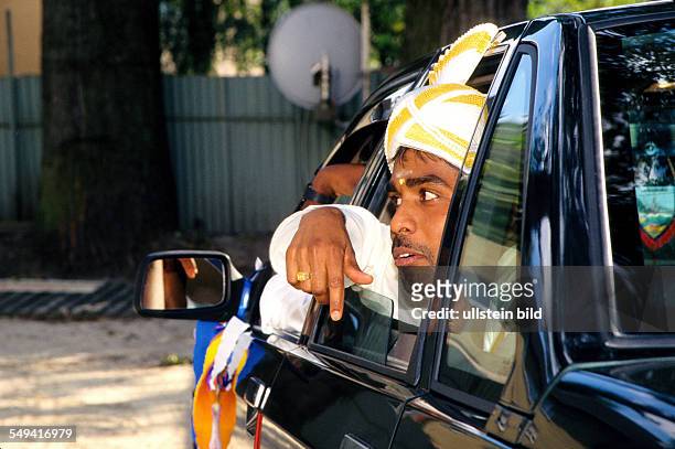 Germany, Hamm, 1999: Hindu-Tamils in Germany.- Wedding; the bridegroom and witness of the marriage in their car in front of the Sri Kamadschi Ambal...