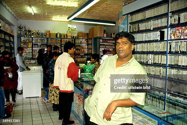 Germany, Hamm, 1999: Hindu-Tamils in Germany.- A Tamil businessman; video library, fruit and vegetable shop.
