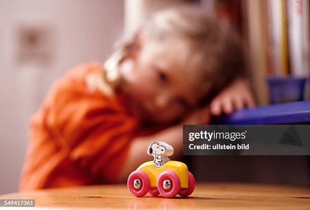 Germany: A child playing with Snoopy.