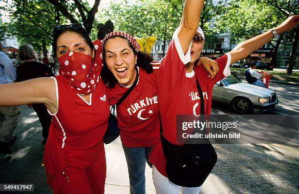 Germany, Berlin, : World Championships.- Turkey against Senegal. Kurfuerstendamm; Turks celebrating the Golden Goal on the roads, line of cars.