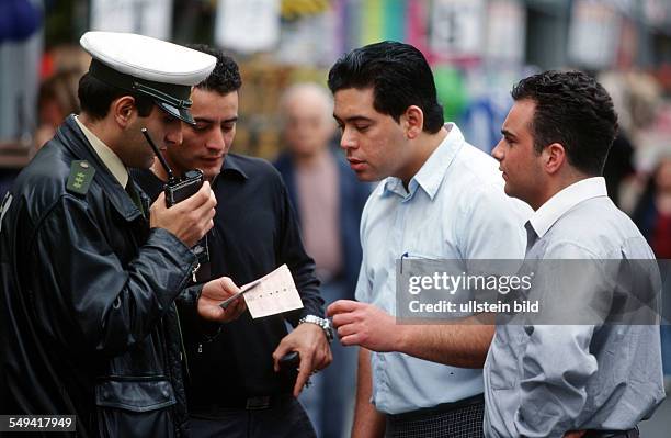 Germany, Krefeld: Police.- Portrait of the turkish senior police master A. Oezen at work. ID check at tuerkish pedestrians.