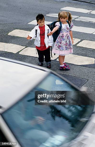 Germany: Primary pupils in the traffic.- At the zebra crossing.