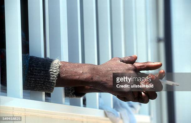 Spain, Tarifa: An immigrant is arrested by the Guardia Civil. He smokes in the collective accommodation