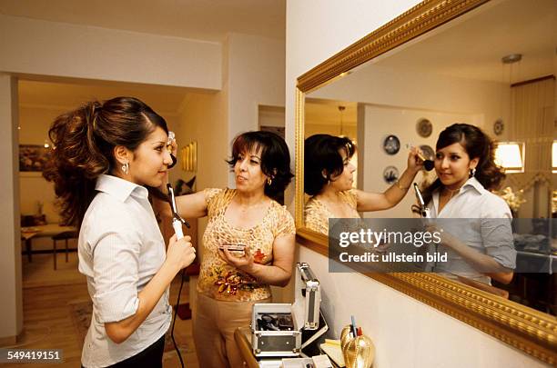 Germany, Dortmund, 06.2002: Turkish Nights in the Ruhr Area.- Kamuran is helping her daughter Ayca with the styling for the evening in the Turkish...