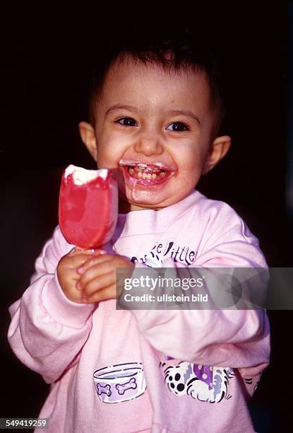 Germany: Infant, 1 1/2 years old, eating ice-cream.