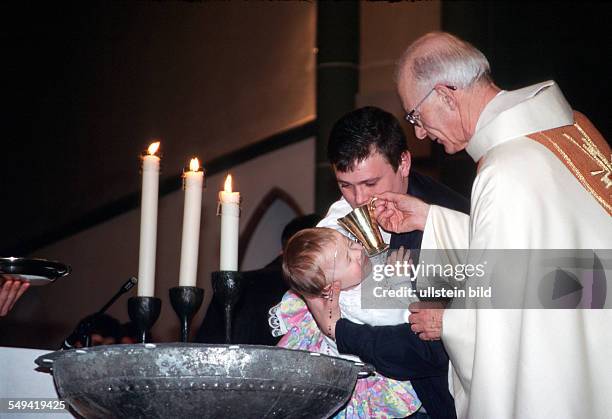 Germany, Luenen, 1999: Baptism of foreigners during the Easter mass, St. Marien Church.