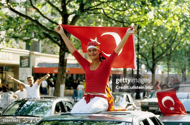 Germany, Berlin, : World Championships.- Turkey against Senegal. Kurfuerstendamm; Turks celebrating the Golden Goal on the roads, line of cars.