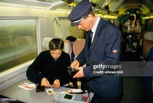 Germany, : Rail traffic; ICE guard selling tickets.