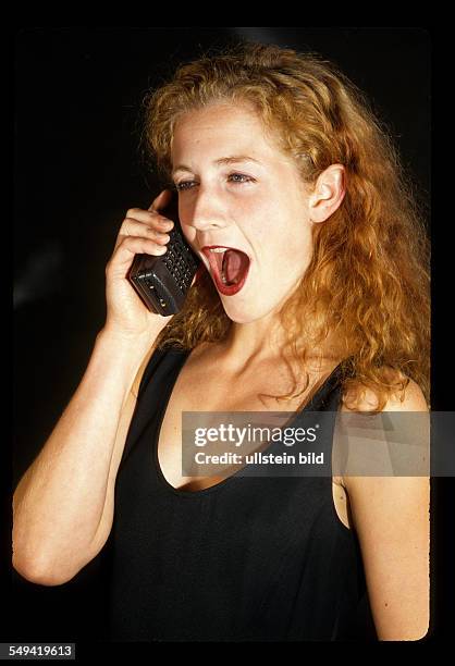 Germany, 1997: Communication; a young woman with a mobile phone.