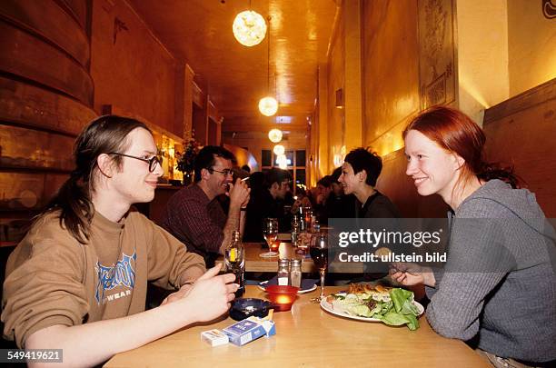 Germany, Berlin: Young persons in a cafe.