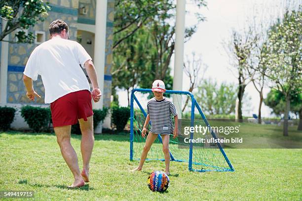 Turkey, Side: Robinson Club.- Pamfilya Hotel; father and son playing soccer.