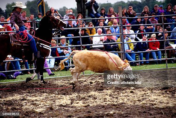 Germany: American rodeo; catching a calf with a lasso.