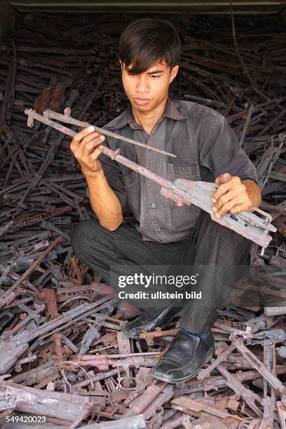 Cambodia. Phnon Penh: the technical department of the Don Bosco school works machine guns to chairs, benches, tables after the demobilization