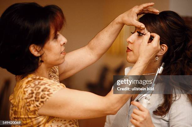 Germany, Dortmund, 06.2002: Turkish Nights in the Ruhr Area.- Kamuran is helping her daughter Ayca with the styling for the evening in the Turkish...