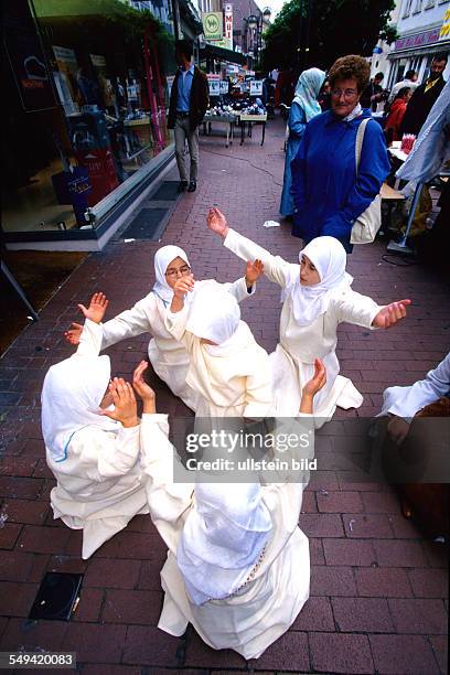 Germany, Luenen: Multicultural festival in the pedestrian precinct.- Turkish children dancing the Mevlana dance .