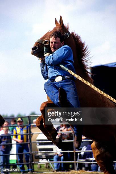 Germany: American rodeo; catching a horse.
