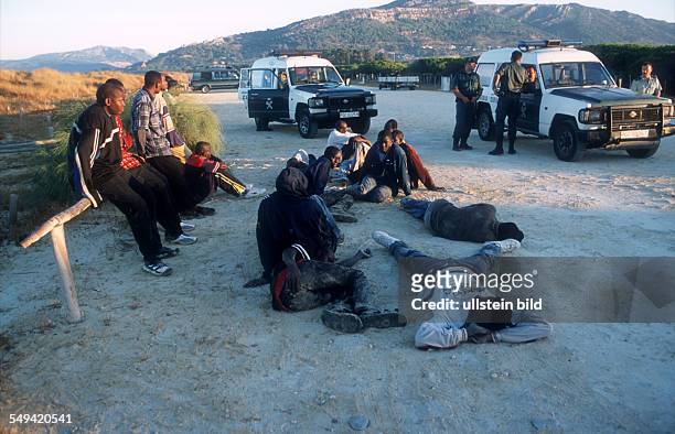 Spain, Tarifa: Africans try to immigrate over the straits of Gibraltar. After their arrival they are arrested by the Guardia Civil.