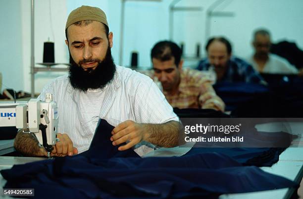 Turkey, Istanbul: TEKBIR, specialized in fashion for muslims. The men are working in the production
