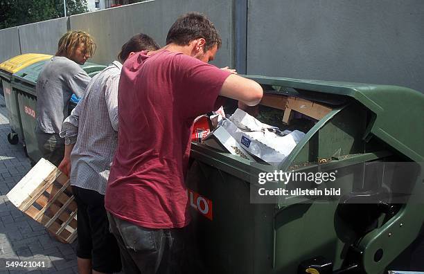 Germany: streetkids are looking for food in garbage cans.