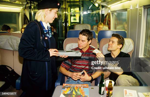 Germany, : Rail traffic; ICE guard selling tickets.