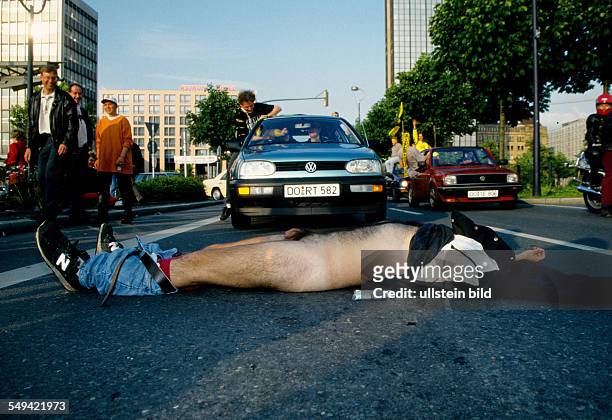 Germany, Dortmund, 1996: Dortmund-City.- BVB-Fans celebrating the championship ; a drunk lying nakedly in front of the car parade.