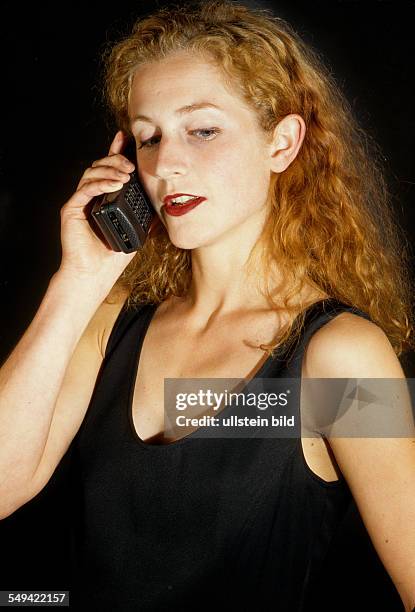 Germany, 1997: Communication; a young woman with a mobile phone.