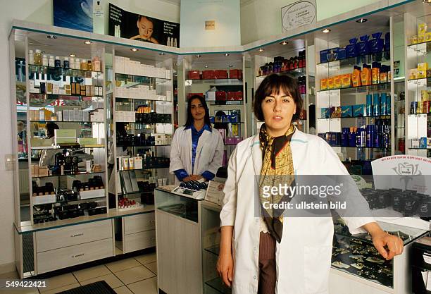 Germany, Dortmund, 1998: Turkish businessmen in Germany.- The female manager of a perfumery and employees .